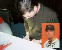 Pat signs an autograph