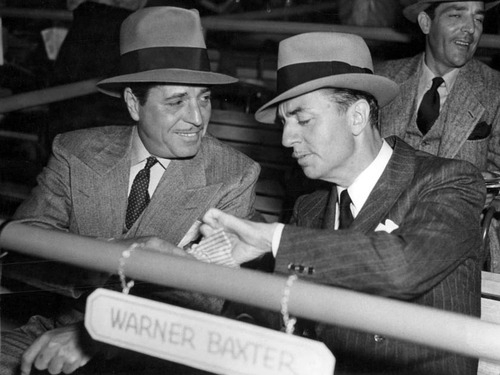 A rare public shot of two reclusive men: Warner Baxter and William Powell at Hollywood Park racetrack, 1938
