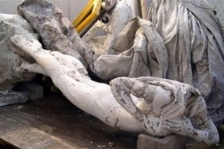 The sad, headless remains of the original statue, after removal in 2000